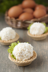   Tartlets with cheese and egg balls and eggs in the basket.