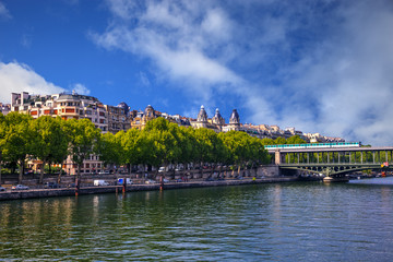 Fototapeta na wymiar Famous quay of river Seine in Paris with buildings and trees.