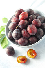 Fresh plums in a bowl