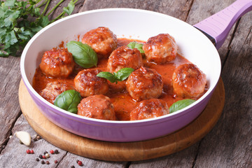 hot meatballs with tomato sauce in a frying pan