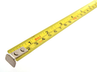 Close up photo of a yellow tape measure on a white background.