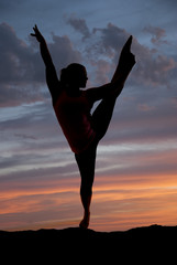 attractive female fitness yoga model silhouetter at sunset