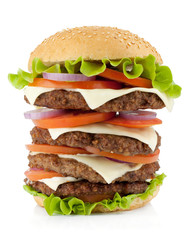 Huge burger with beef, cheese, onion and tomatoes