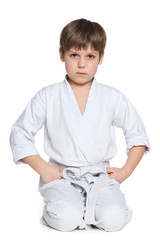 Little boy in kimono sits on the floor