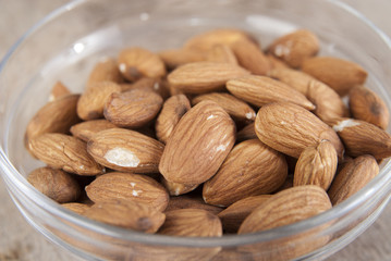 Top view of glass bowl full of almonds