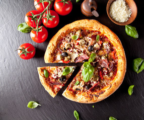 Fresh italian pizza served on black stone