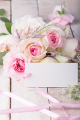 Obraz na płótnie Canvas Postcard with elegant flowers and empty tag for your text