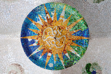 Naklejka premium Season mosaic with orange sun at sala Hipostila in Park Guell at