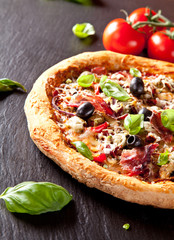 Fresh italian pizza served on black stone