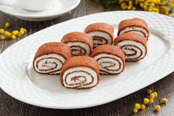 Rolls of chocolate pancakes with cottage cheese.