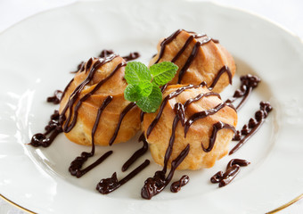 profiteroles with cream and chocolate sauce.