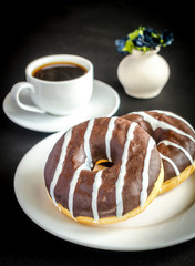 Chocolate donuts with a cup of coffee