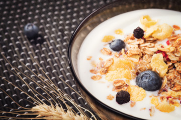 Plate of muesli with yogurt and fresh berries. Background