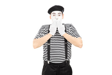 Shocked mime artist standing in disbelief