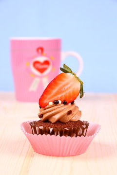 Chocolate cupcakes with strawberry and coffee cup