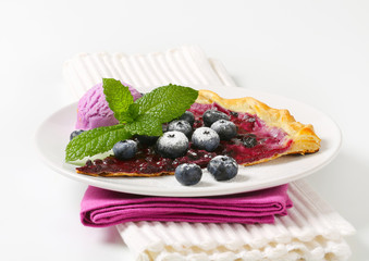 Slice of blueberry tart with ice cream