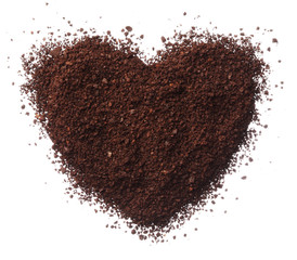 Ground coffee heart isolated on white background close up