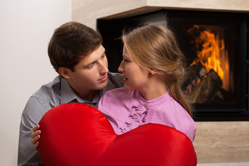 Couple in love by fireplace