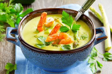 Cream of asparagus soup with shrimp.