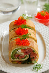 roll pancakes with red fish and avocados.
