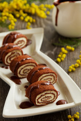 Rolls of chocolate pancakes with cottage cheese.