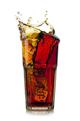 Splashing cola in glass. Isolated on white background