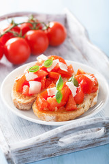 Italian bruschetta with tomatoes, parmesan, garlic and olive oil