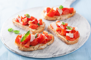 Italian bruschetta with tomatoes, parmesan, garlic and olive oil