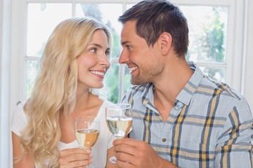 Loving couple with wine glasses looking at each other