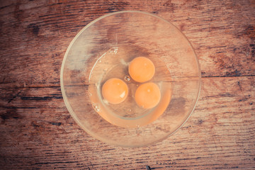 Three raw eggs in a bowl
