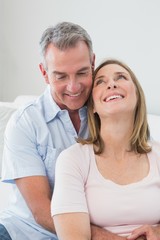 Happy couple embracing in the living room