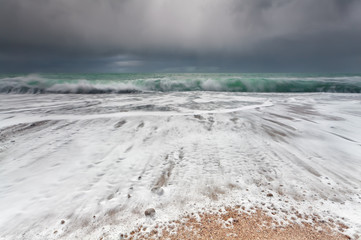 ocean waveson sand beach during storm