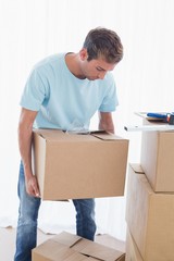 Man with cardboard boxes in new house