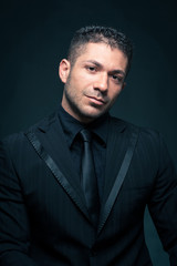 Fototapeta premium Elegant man close up portrait against dark background.