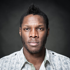 Obraz premium Intense man close up portrait against dark background.