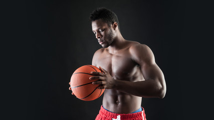 Portrait of confident young black man shirtless with basket ball