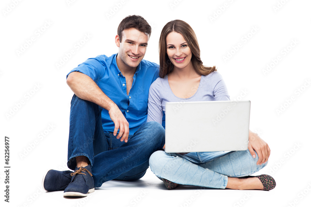 Wall mural couple sitting with laptop