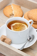 black tea with lemon and cookies, vertical