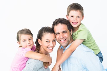 Fototapeta premium Cheerful young family looking at camera together