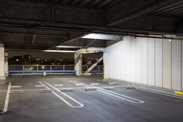 Parking garage underground interior, neon lights in dark