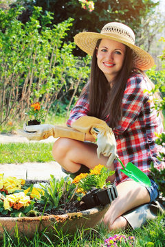 Beautiful young gardener smiles in a relax pose