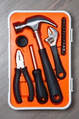 orange tools box against wooden background