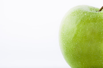 Green Granny Smith apple with waterdrops