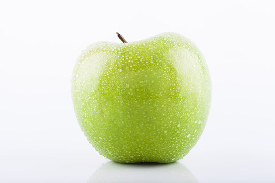 Green Granny Smith apple with waterdrops
