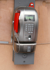 ancient coin-operated phone with phone booth