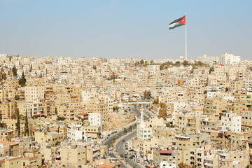 Amman city view with big Jordan flag