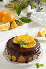 Orange cake with chocolate and orange slices.