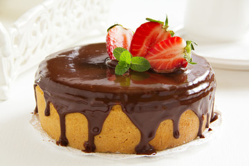 Sponge cake with chocolate cream and strawberries.