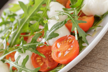 salad from arugula tomatos and baby mozzarella