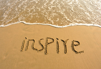 word inspire drawn on beach